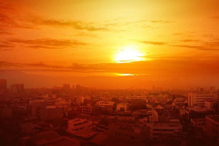 sunset over a red hue city landscape