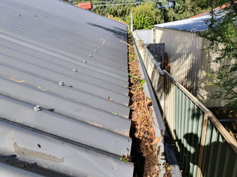 taking care of your roof is important, image demonstrates a roof with clogged gutters which need clearing