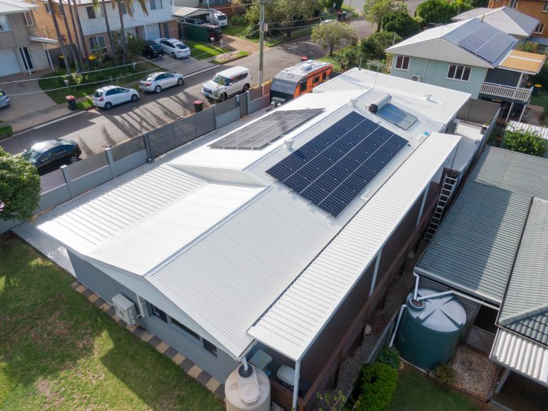 A Brisbane building with solar panels on after a metal roof replacement