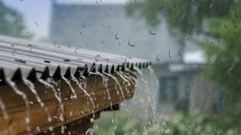 Heavy rain pouring of a metal roof