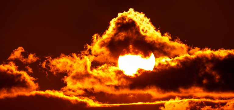 Hot sun surrounded by clouds