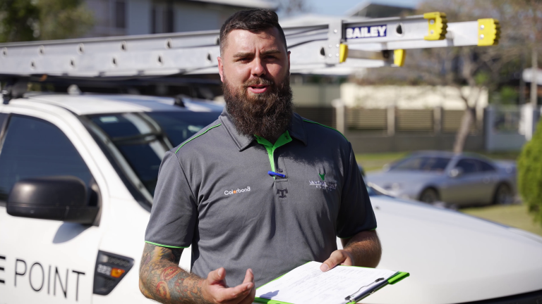 Vantage Point Roofing expert posing with a clipboard