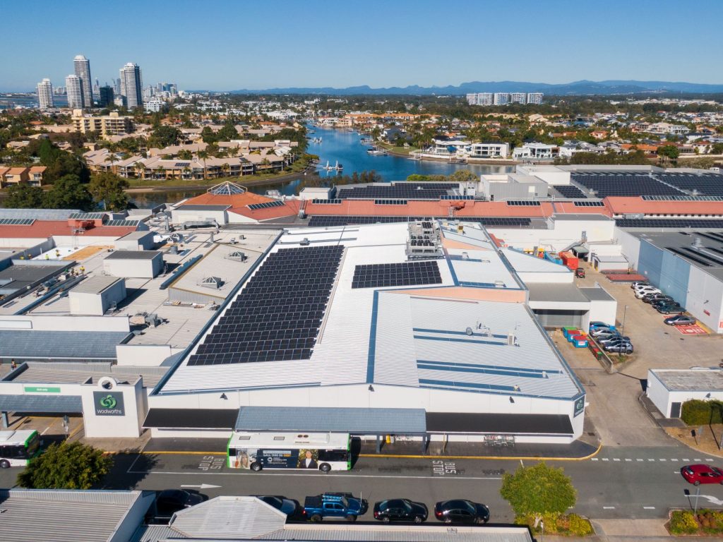 aerial view of a large commercial building with new metal roof and solar panels