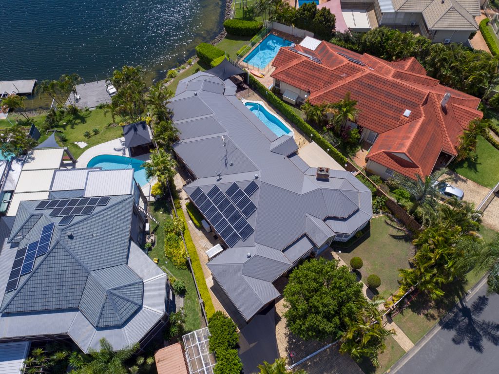 The finished roof of a large residential property by the water