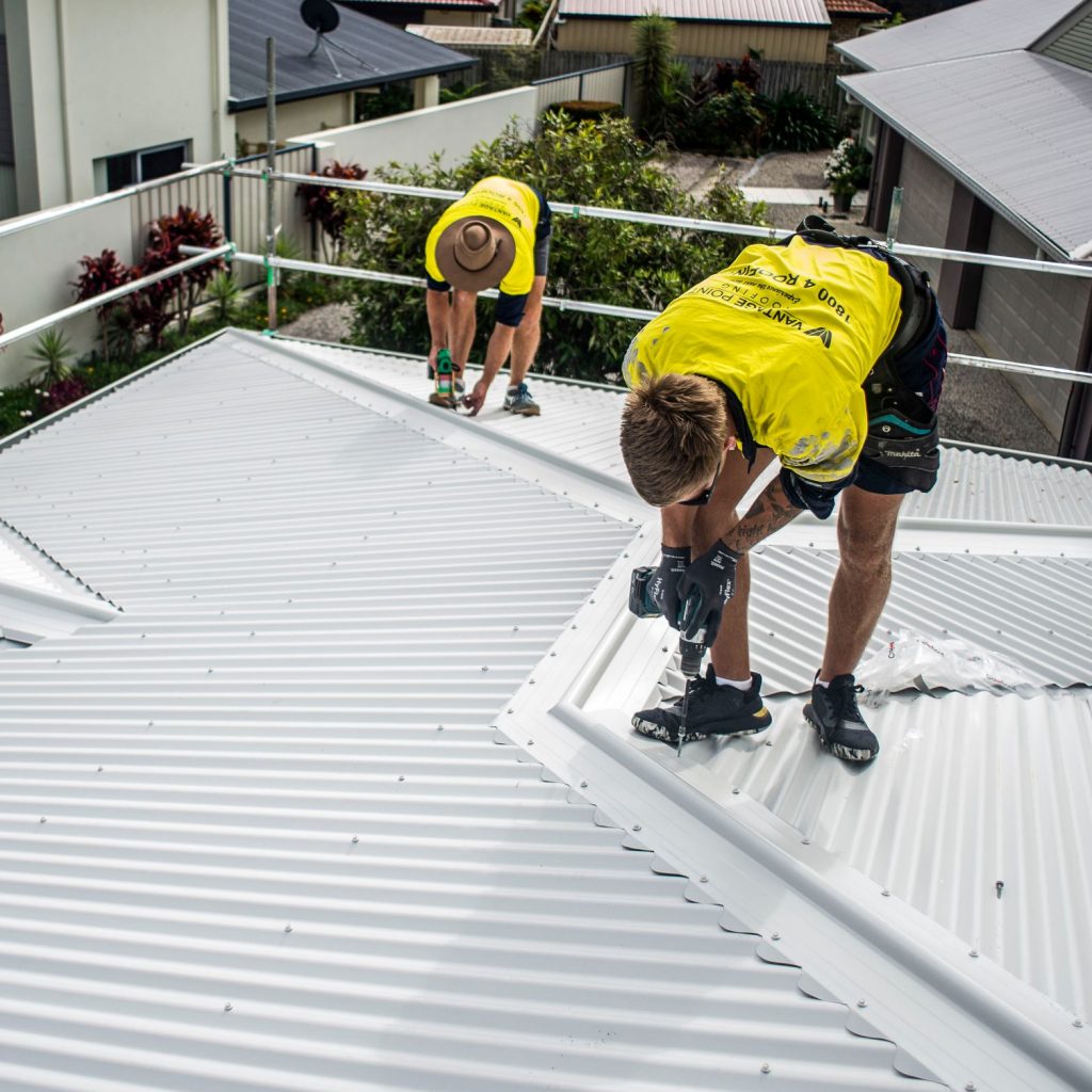 The vantage point roofing team installing new metal roofing