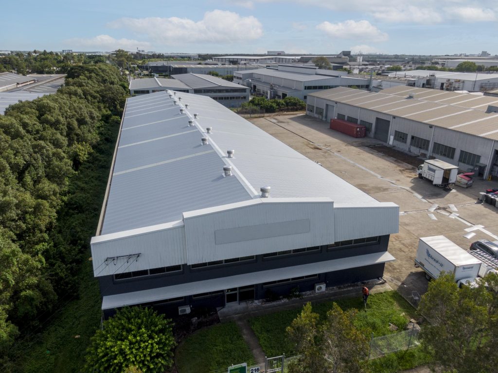 A large commercial building with new metal roofing