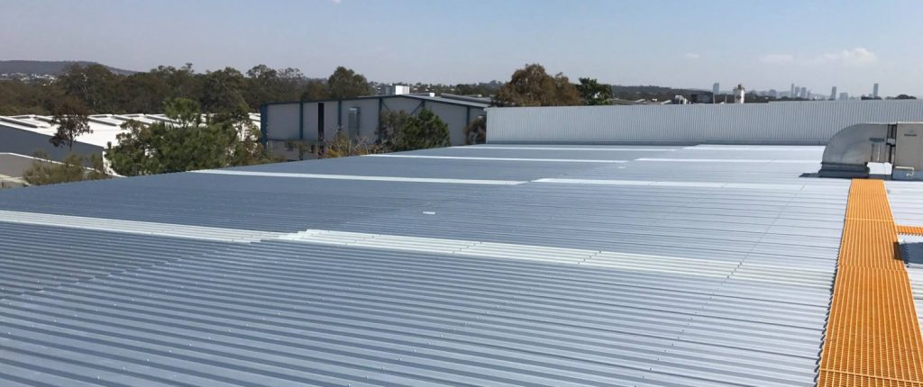 Commercial roofing after replacement with translucent roof sheeting strips.