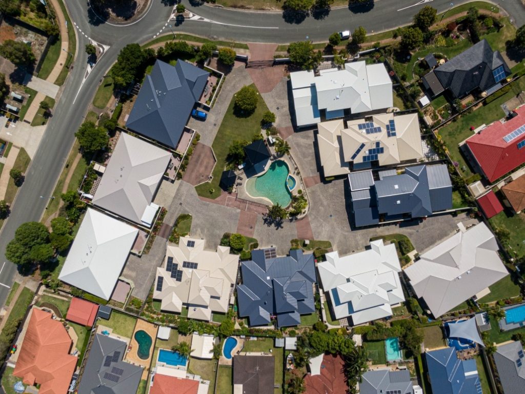 residential area aerial view showing homes with new metal roofs