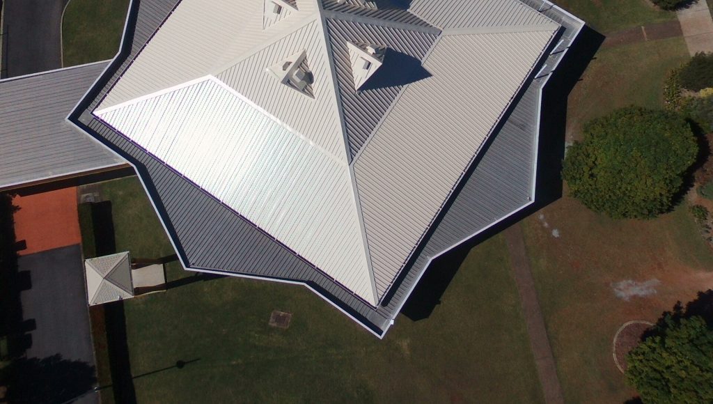 Aerial photograph of a building with a new metal roof